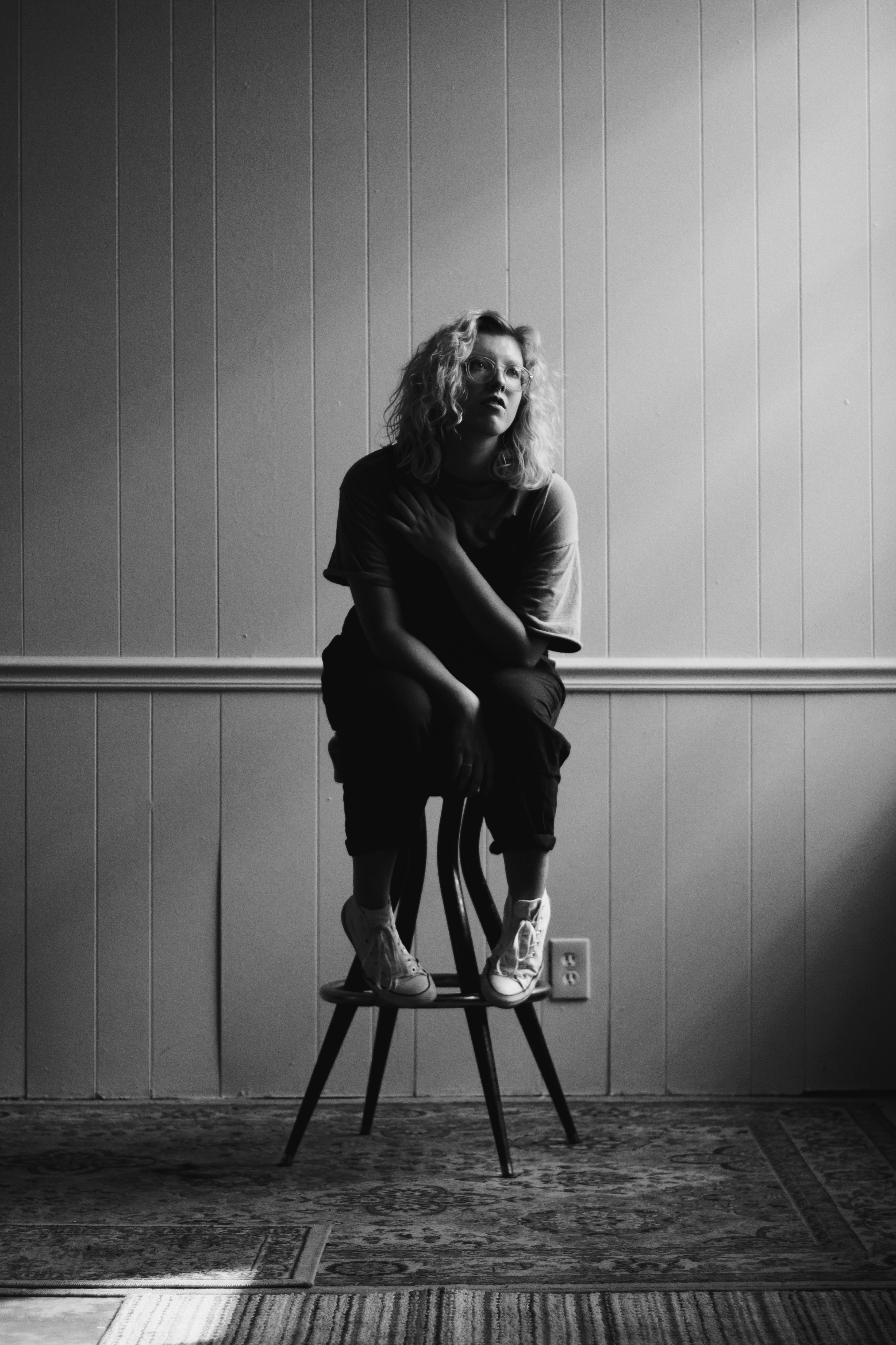 grayscale photography of woman sitting on chair